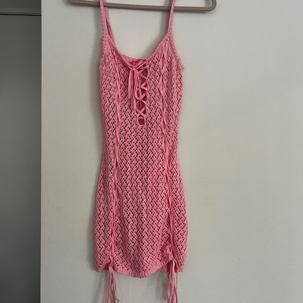 Crochet lace-up mini dress by DollsKill, baby pink
